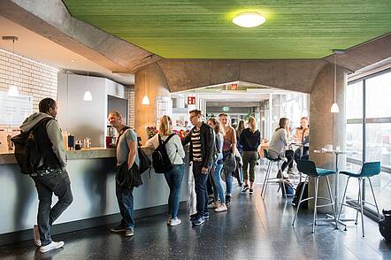 Foto: Studierende stehen an der Theke der Coffeebar der Evangelischen Hochschule Berlin