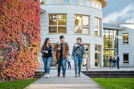 Foto: Studierende gehen über den Campus der Evangelischen Hochschule Dresden und unterhalten sich